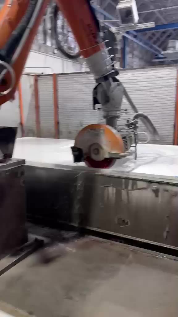Robotic bridge saw cutting a quartz slab in the shop